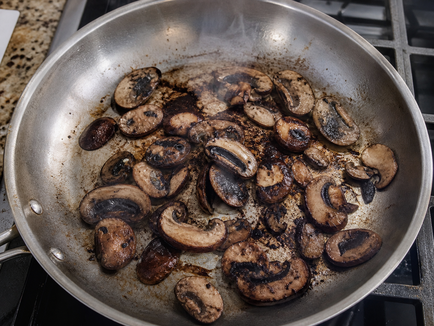 Mushrooms scorching and smoking in a pan that is too hot