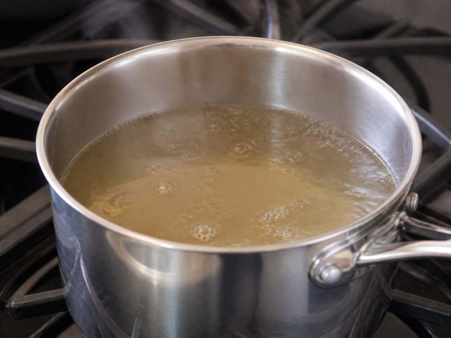 Liquid at a gentle simmer with small occasional bubbles